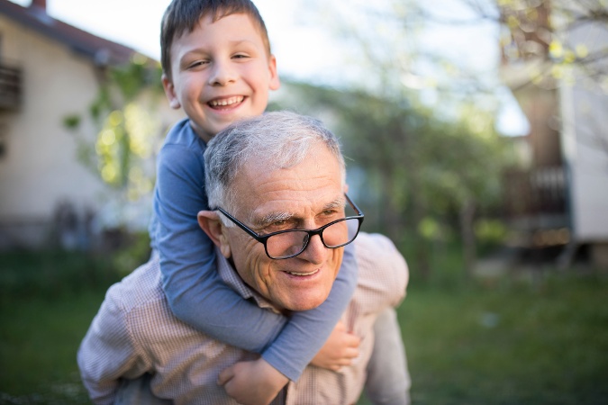 Young Boy on Older Mans Back